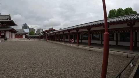 Ground Level View of Ancient Buddhist Temple Courtyard with Red Pillars in Stock Footage 337669797