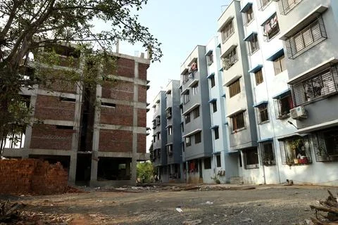 A ground level view of a completed apartment and a under construction apartme Stock Photos