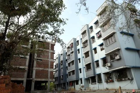 A ground level view of a completed apartment and a under construction apartme Stock Photos
