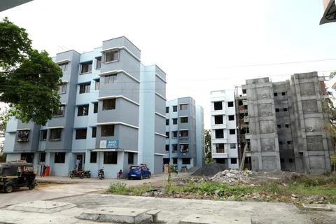 A ground level view of a completed apartment and a under construction apartme Stock Photos