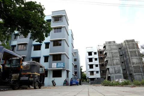 A ground level view of a completed apartment and a under construction apartme Stock Photos