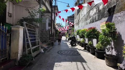 Ground Level View Down Narrow Urban Alley With Bunting Stock Footage 345203258