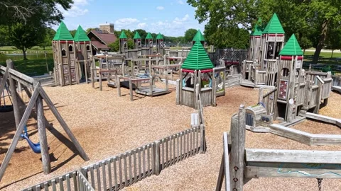 Ground level view of an empty wooden castle playground in a park Stock Footage 340550755