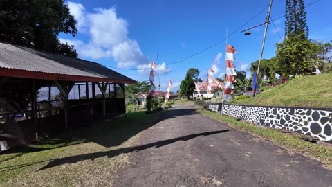 Ground Level View Of Gucialit Village Road Flags Stock Footage 345153287