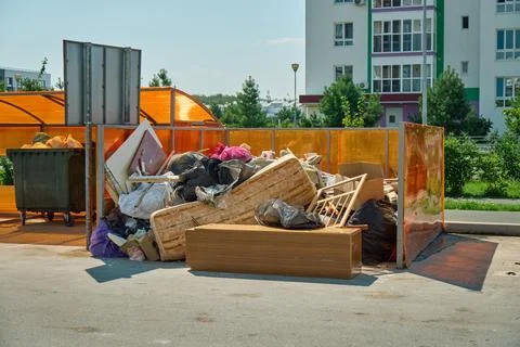 Ground-level view of mixed trash, broken plastic items, and unsorted rubbis.. Stock Photos