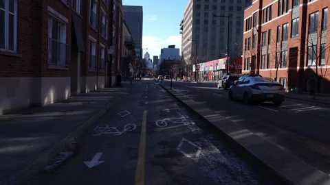 Ground-level view of a paved bike lane with painted bicycle symbols between 스톡 동영상 333874404