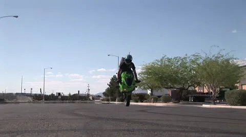 Ground Level View Of a Rider Doing A Back Tire Wheelie 스톡 동영상 18971035