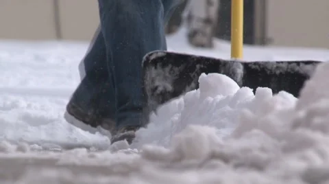 Ground level view of snow shovel pushing snow toward the camera. Stock Footage 47342664