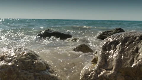 Ground Level View of Waves Splashing Over Rocks on Shore Stock Footage 346663000