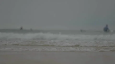 Ground-level waves with surfer behind Stock Footage 346282196