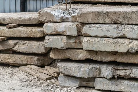 On the ground lies a stack of old concrete slabs. Stock Photos