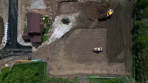 Ground machines are moving and preparing land at a construction site in Stock Footage 337316105