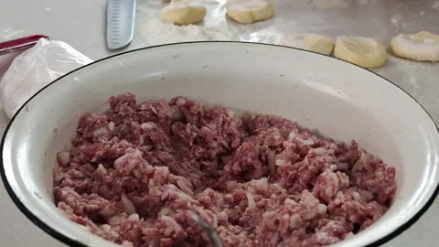 Ground meat being stirred with a spoon on a kitchen counter top-down view Stock Footage 343514604