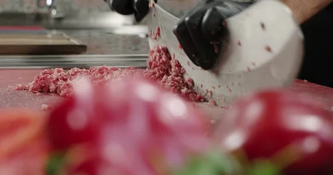 Ground meat preparation. Chef chops meat using big knife or axe. Handmade ground Stock Footage 274674991