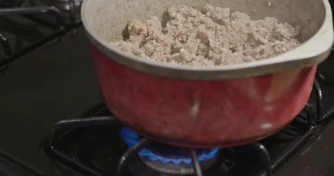 Ground meat in red pot over gas burner Stock Footage 308653364
