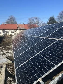 Ground-Mounted Solar Panel Array in Rural Setting - Renewable Energy Installatio 写真素材