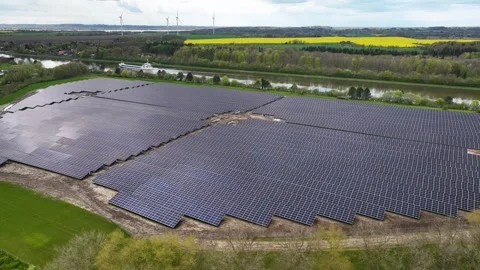 Ground-mounted solar panels neighboring canal. Stock Footage 273565054