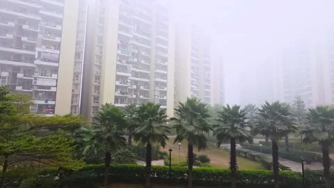 Ground panning shot showing multi storey skyscraper builds hidden in the fog Stock Footage 331315124