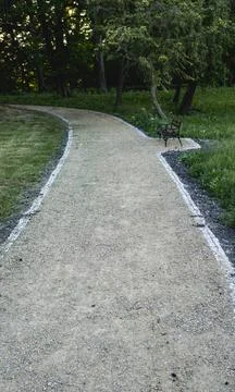 Ground path through a park made of small rocks Stock Photos