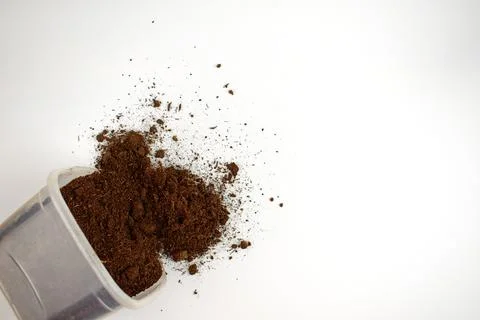 Ground in a plastic box on a white background. Ground is is scattered. Isolat Stock Photos