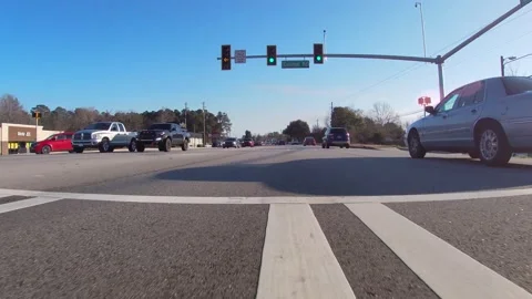 Ground POV view passing Walmart on Belair road passing through a traffic ligh Stock Footage 148695427