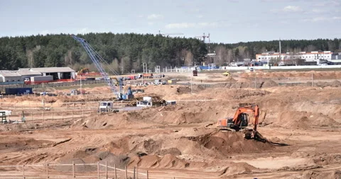 Ground Preparation and Soil Leveling with Excavators: Initial Stage of High-Rise Stock Footage 242230760