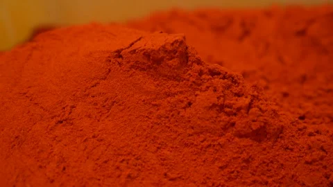 Ground red pepper powder creating a textured background for culinary concepts Stock Footage 333520717