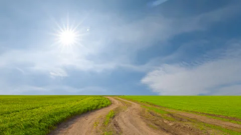 Ground road among green fields under a sparkle sun Stock-Footage 320192986