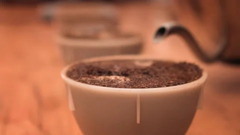 Ground roasted coffee with pouring water. Macro. Brown powder. Stock Footage 147103462