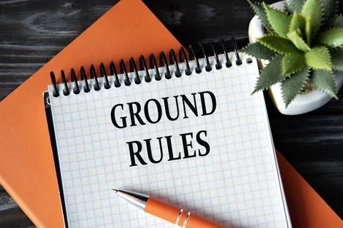 GROUND RULES - words in white notebook on dark wooden background with cactu.. Stock Photos