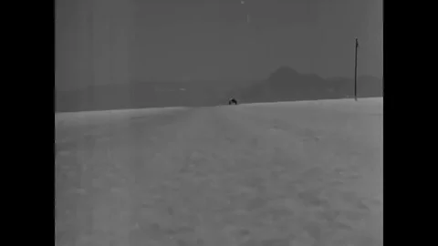 Ground speed records are broken by fast race cars on the salt beds of California Stock Footage 107668606