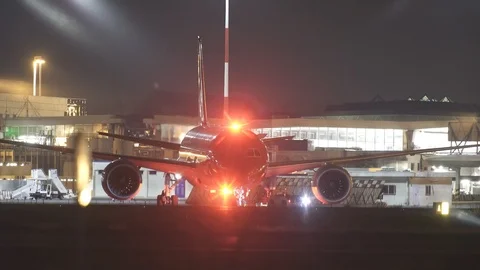 Ground staff is moving a plane to the terminal, high quality night footage Stock Footage 90169710