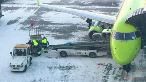 Ground staff working on luggage unloading at airport Stock Footage 327363600