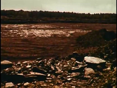 The ground swells and explodes rocks, stones, dirt and dust, in a field, during Stock Footage 75082546
