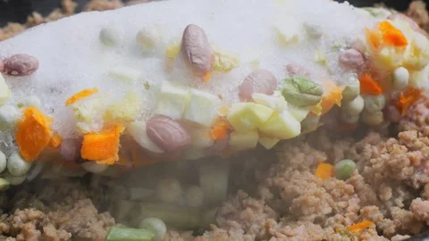 Ground turkey is fried in a frying pan in vegetable oil with frozen vegetab.. Stock Footage 304518209