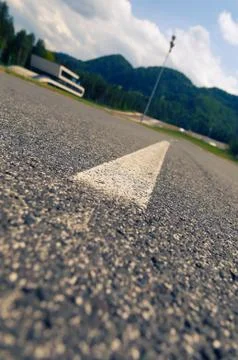 Ground view of asphalt on proving ground with building and hills in background Stock Photos