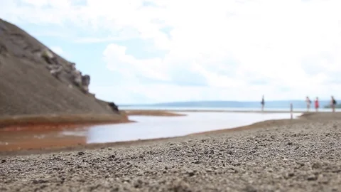 Ground view of red hot volcanic spring with blue sky Stock Footage 89588231