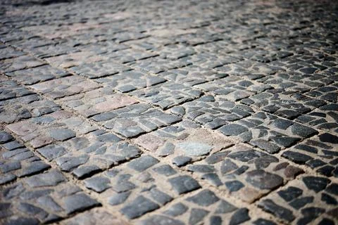 A ground view shows a cobblestone path made of uneven stones. Some gaps have  Stock Photos