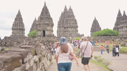 Ground view visitors walking to Prambanan temple (candi prambanan). Stock Footage 248885136