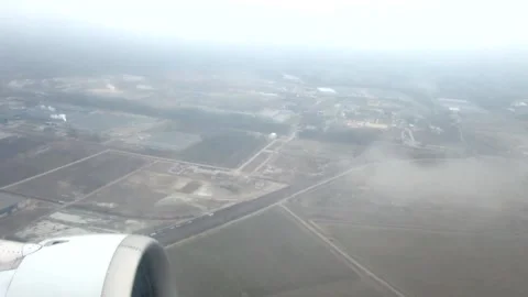 The ground from the window of a flying plane Stock Footage 148619072