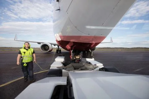 Ground Worker Standing By Aircraft With Communication Cable On R Stock Photos