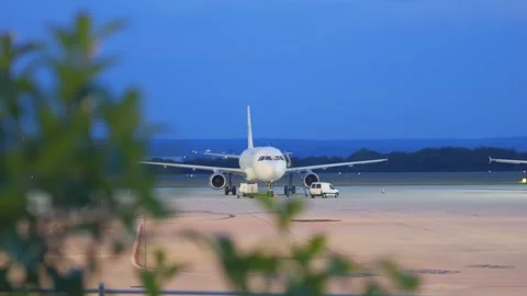 Grounded airplane on tarmac with engine covers in 4k slow motion 60fps Stock Footage 286803695
