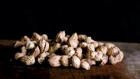 Groundnuts in black background with lights Stock Footage 212789081