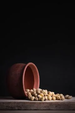 Groundnuts falling from a clay pot Fotos de archivo