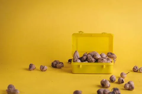Groundnuts on yellow background Fotos de archivo