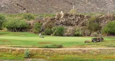 Grounds keeper mowing golf putting greens near Loreto, Mexico. 스톡 동영상 113352535
