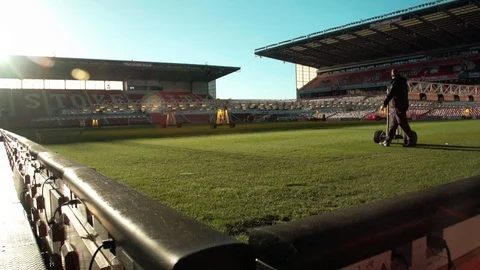 Groundskeeper tends to stadium grow lighting at bet365 Stadium Stock Footage 114625941