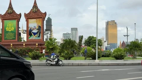 Groundskeepers maintaining the landscape at a public park in Cambodia 스톡 동영상 341692615