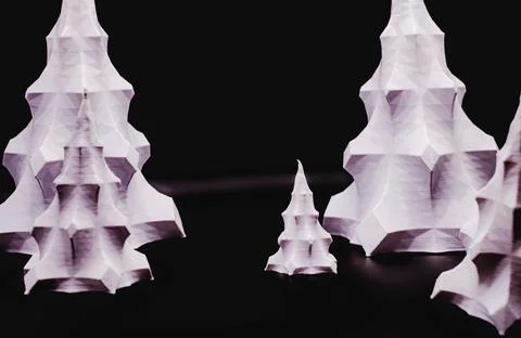 A group of 3D printed objects that look like white Christmas trees against a 写真素材