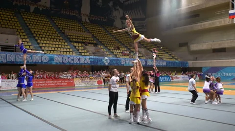 Group acrobatic performance of the cheerleading team with crazy jumps. Stock Footage 62733183
